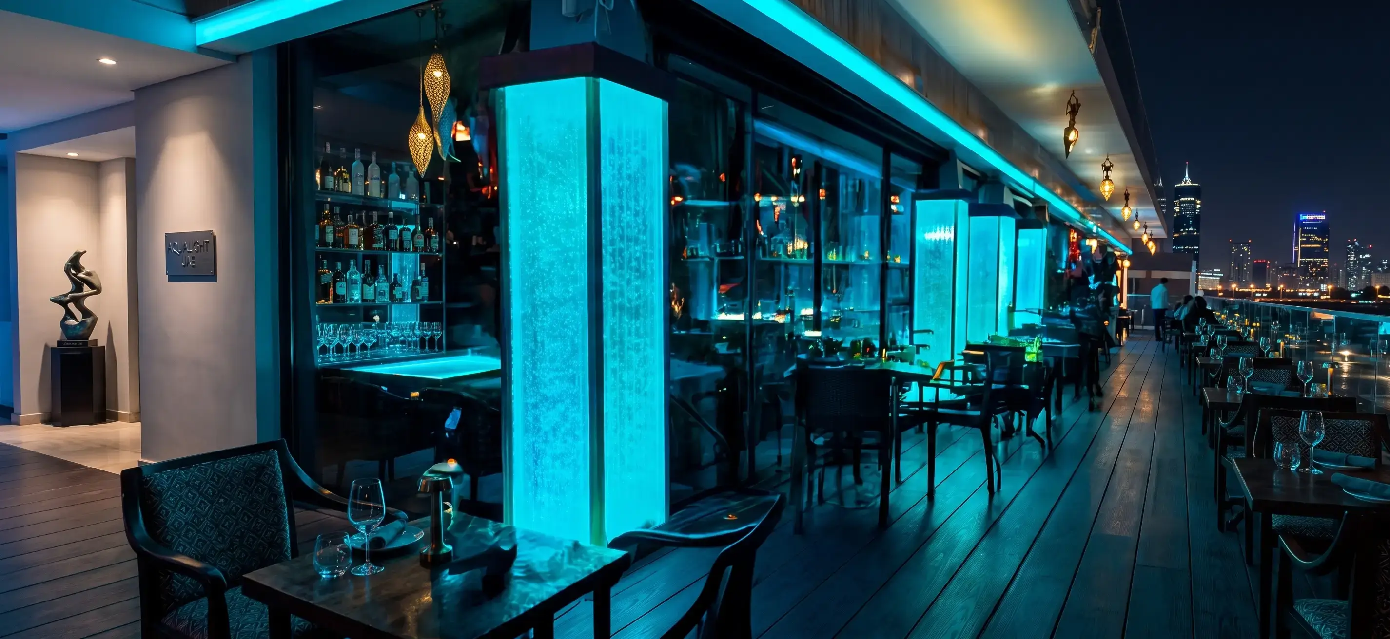 Modern restaurant interior featuring Aqualight LED bubble walls with vibrant blue lighting