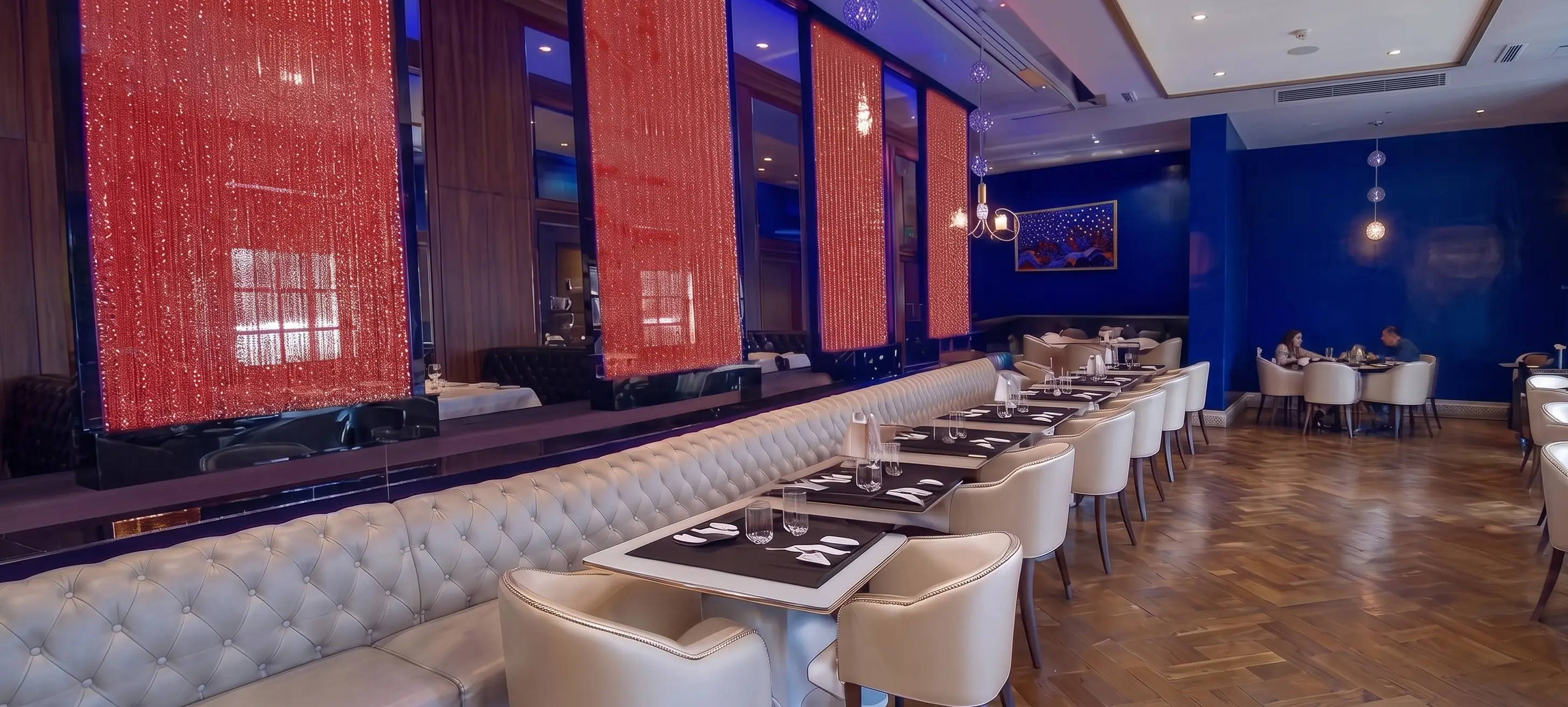 Modern restaurant interior featuring Aqualight LED bubble walls with vibrant blue lighting